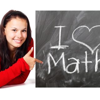 young girl with sign that says i love math
