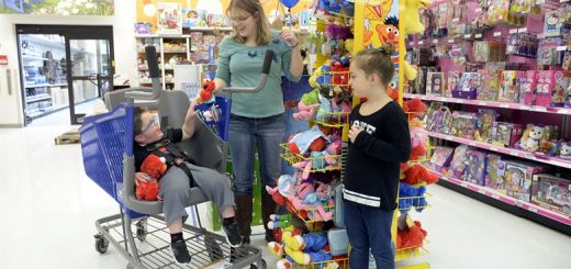 child with a physical disability shopping with his family
