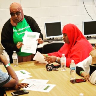 Students and teacher wearing hijabs at table