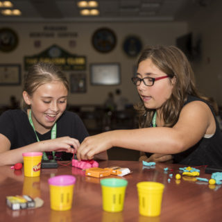 two girls playing with play dough