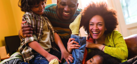 Family: dad, mom, young girl, and young boy playing together