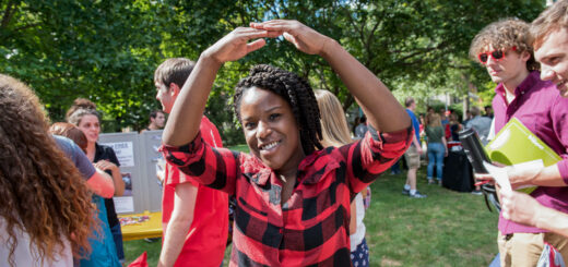 College student outside creating 'O' from Ohio with her arms