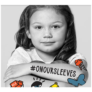 Black and white photo of young girl with #ONOURSLEEVES on her arm