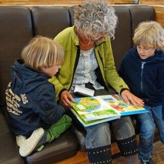 Grandmother reading to her two grandchildren