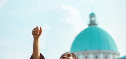 Female student graduate tossing her mortar in the air