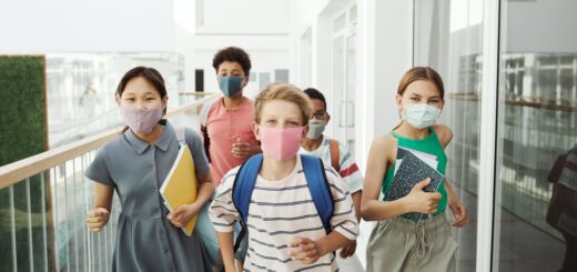 diverse looking group of middle school children wearing face masks at school