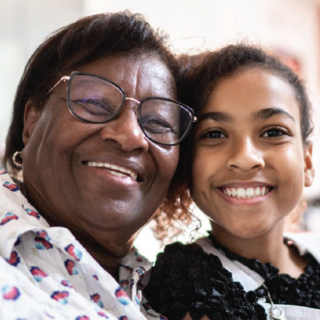 close up of Black grandmother with middle school aged granddaughter