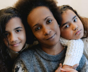 mother and two daughters embracing