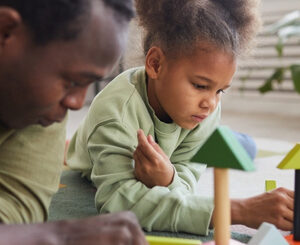 Adult and child playing with blocks