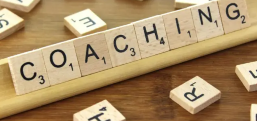 scrabble game letters spelling out the word "coaching"